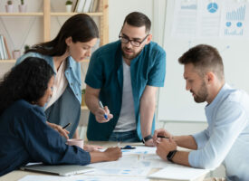 Motivated,Multiracial,Diverse,Businesspeople,Brainstorm,Work,Together,On,Paperwork,At QQI course online level 6